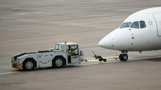 Ground crew taxi-ing an airplane