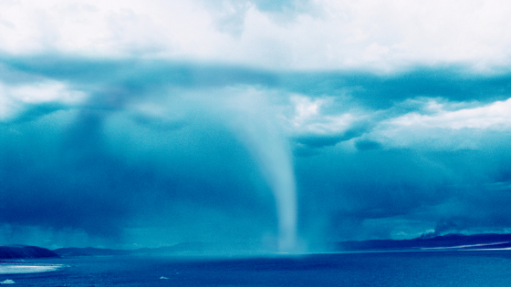 A waterspout, or tornado that forms over a body of water
