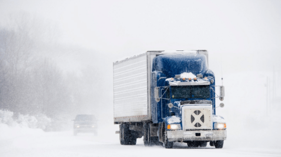Truck driving through a snow storm