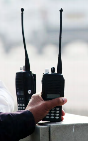 Hand reaching for two radios