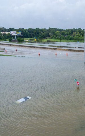 Flooded roadway with a car underwater