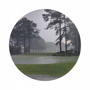 Torrential downpour with lightning strikes at a golf course