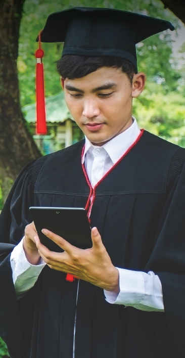 college graduate looking at a tablet 