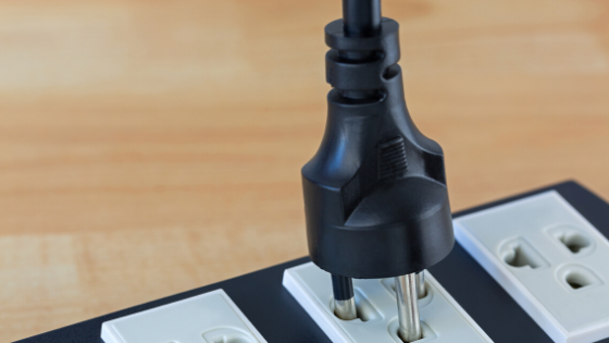 A plug going into a socket to represent how checking your power connection can help you get your weather station running