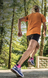 Woman running on pavement at a park