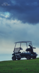 Abandoned golf cart on a green with storm clouds overhead