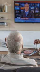 Man watching the weather on the news on TV